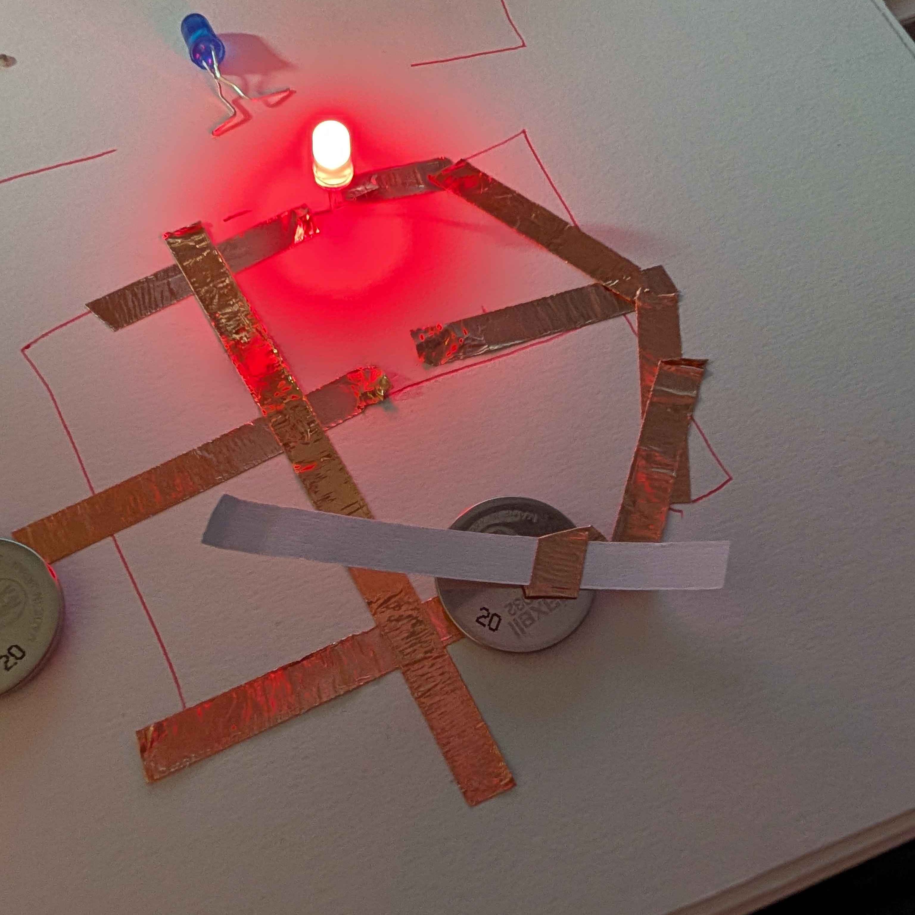 I used the tape strips left from the copper tape to help make the flap easier to make without balling up the copper tape. I also drew the cirut with symbols of which side the led is supposed to be placed to make it easier for me.