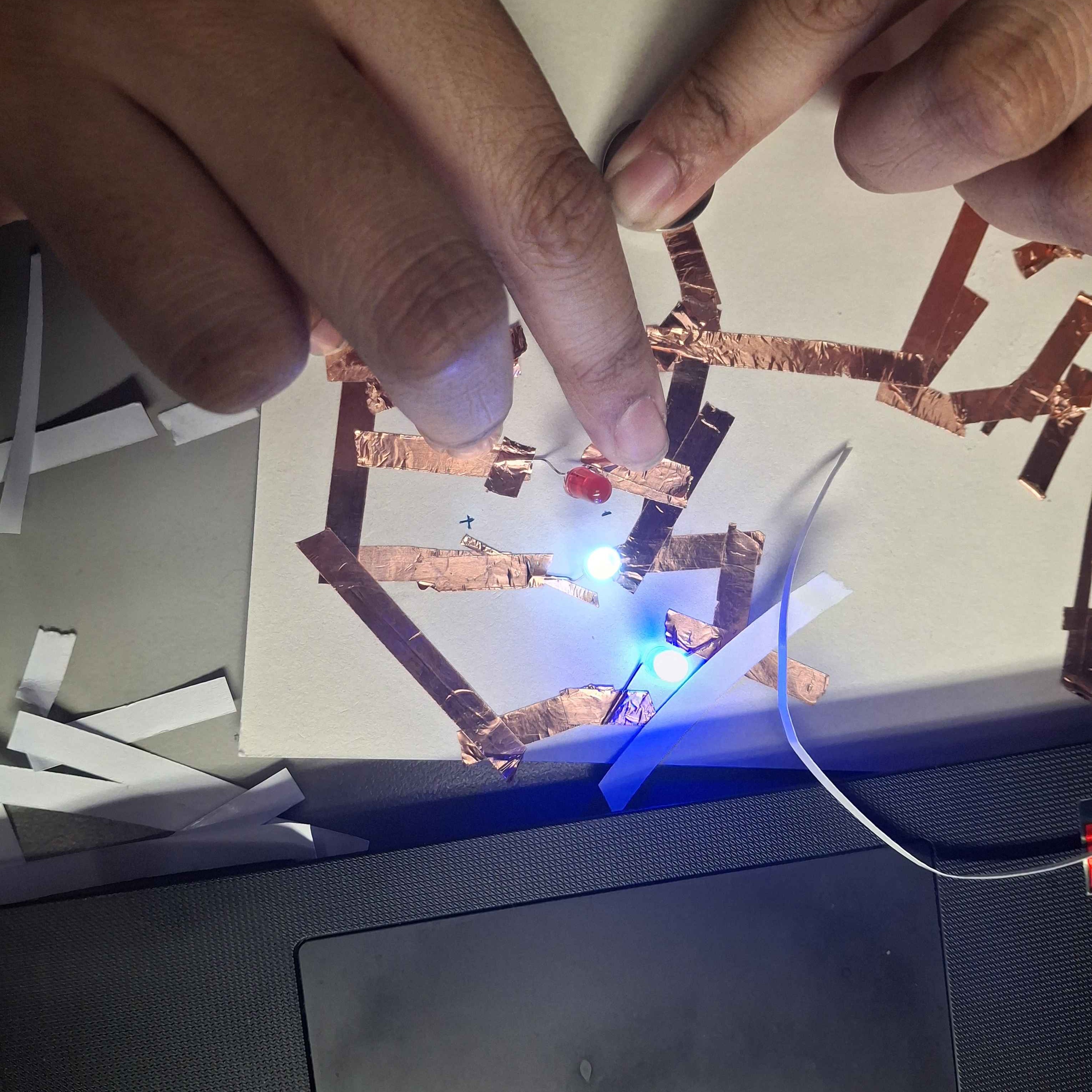 Another view of me trying to get all 3 lights to work as intended, at this stage, only one of the lights didn't want to light up, I was under the assumption that this was a connection issue within the circut I had created and then began to plsy around with the layout to solve this issue.